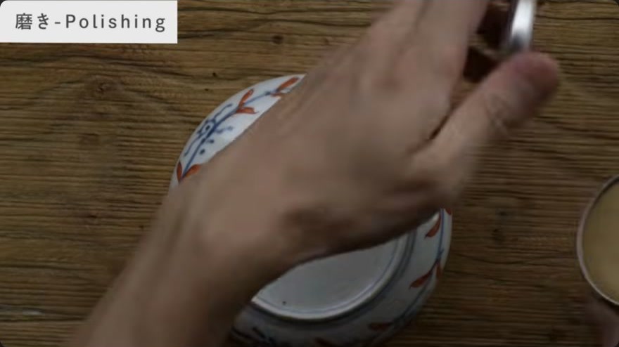 Polish to reveal the metallic surface — The artisan rubs polishing compound along the fixed metal line to bring up its final lustre.