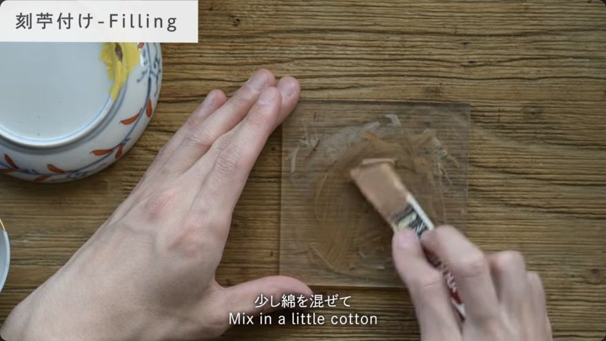 Mix the kokuso or sabi filler — The maker folds cotton fibre into the smooth tonoko-and-urushi paste to form kokuso filler.