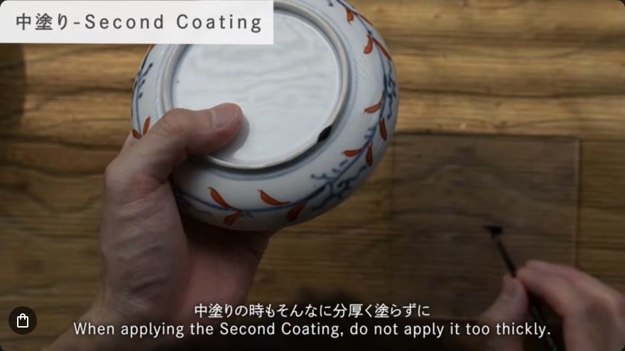 Apply middle coats (naka-nuri) of kuro-urushi — A fine brush lays an even black middle coat along the repaired line.
