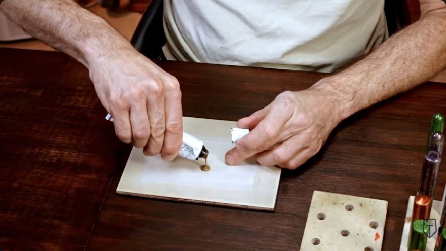 Filter and portion the lacquer — Lacquer is dispensed from the tube onto Yoshino filter paper.
