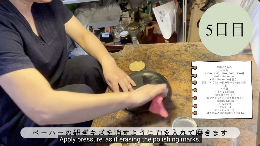 Polish with cream compound (Kikumo or equivalent) — The maker works polishing cream into the lacquer with a soft cloth and firm circular pressure.